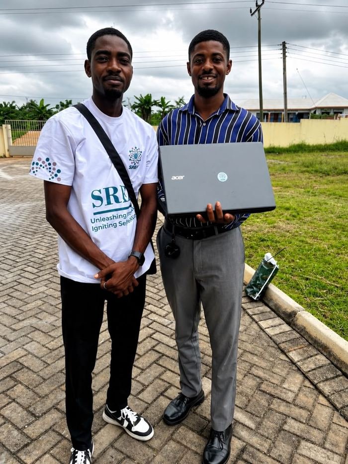 A laptop being presented to an SREF beneficiary